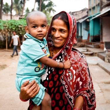 Mother-holding-child-in-village
