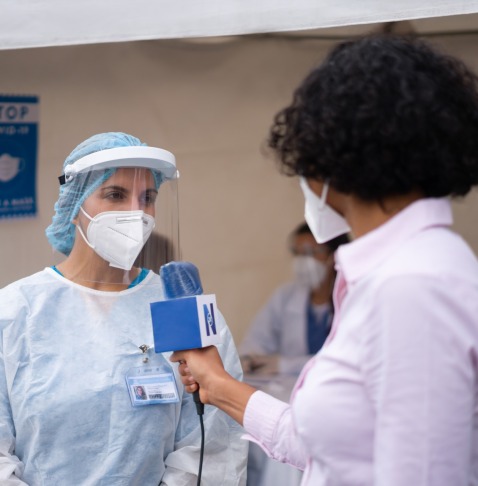 Journalist interviewing health worker