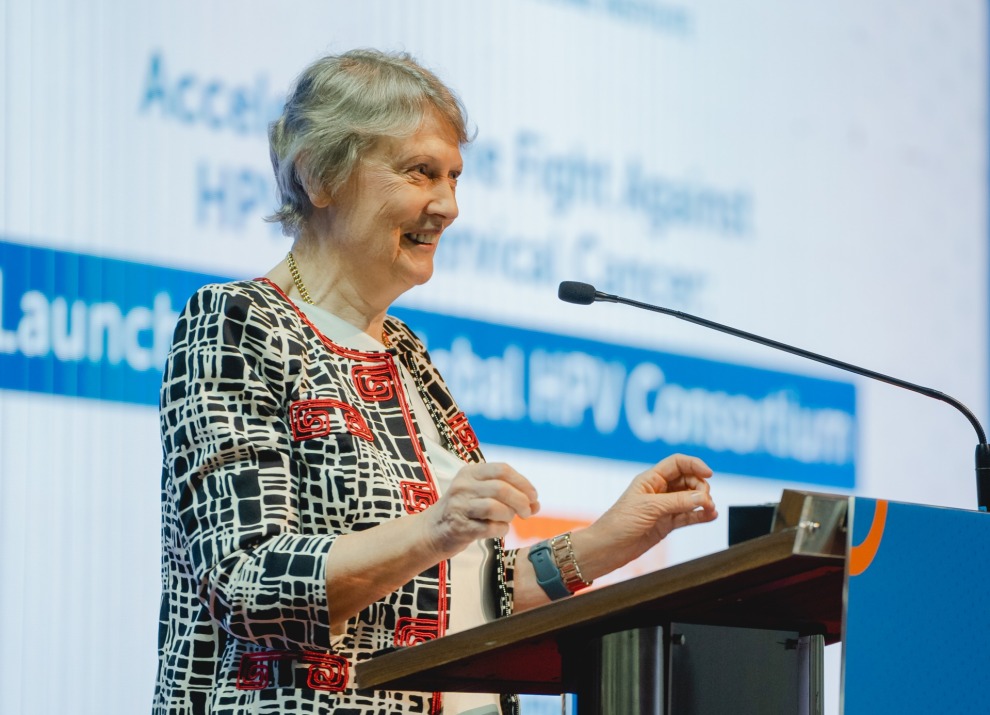 Helen Clark at a podium at the Global HPV Consortium