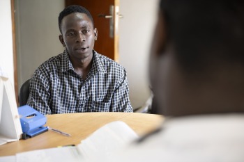 Charles Muiiu, a patient in the Sabin Vaccine Institute Marburg trial consulting with doctor.