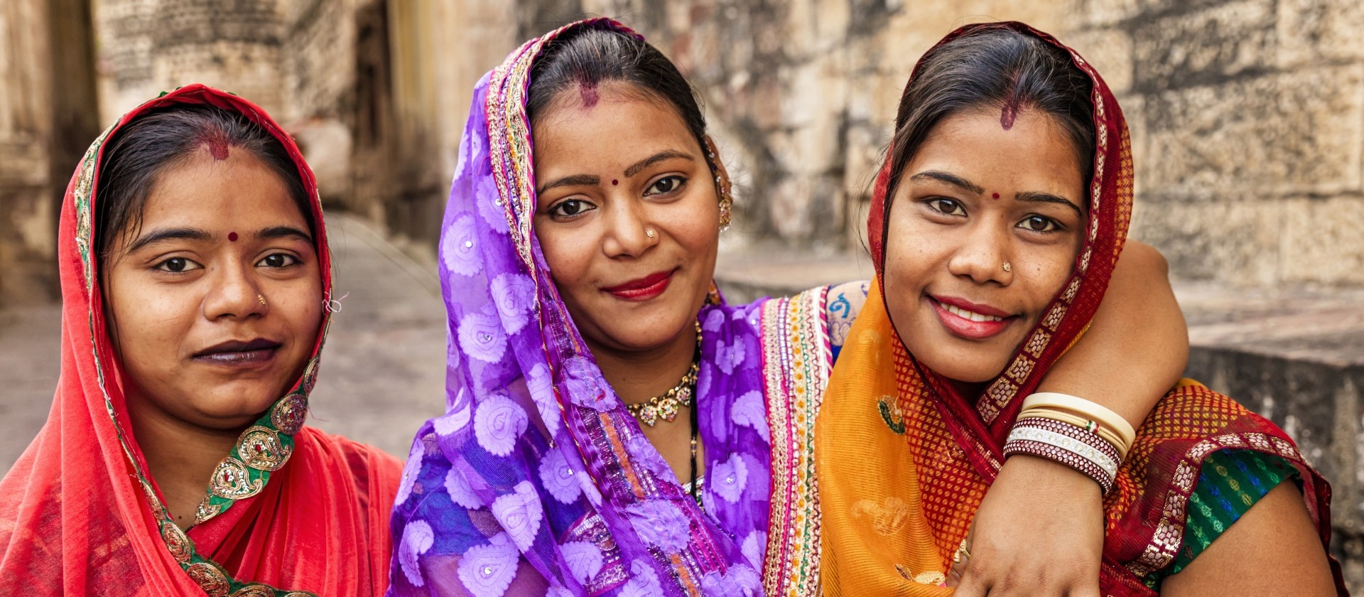 Three women smiling at the camera