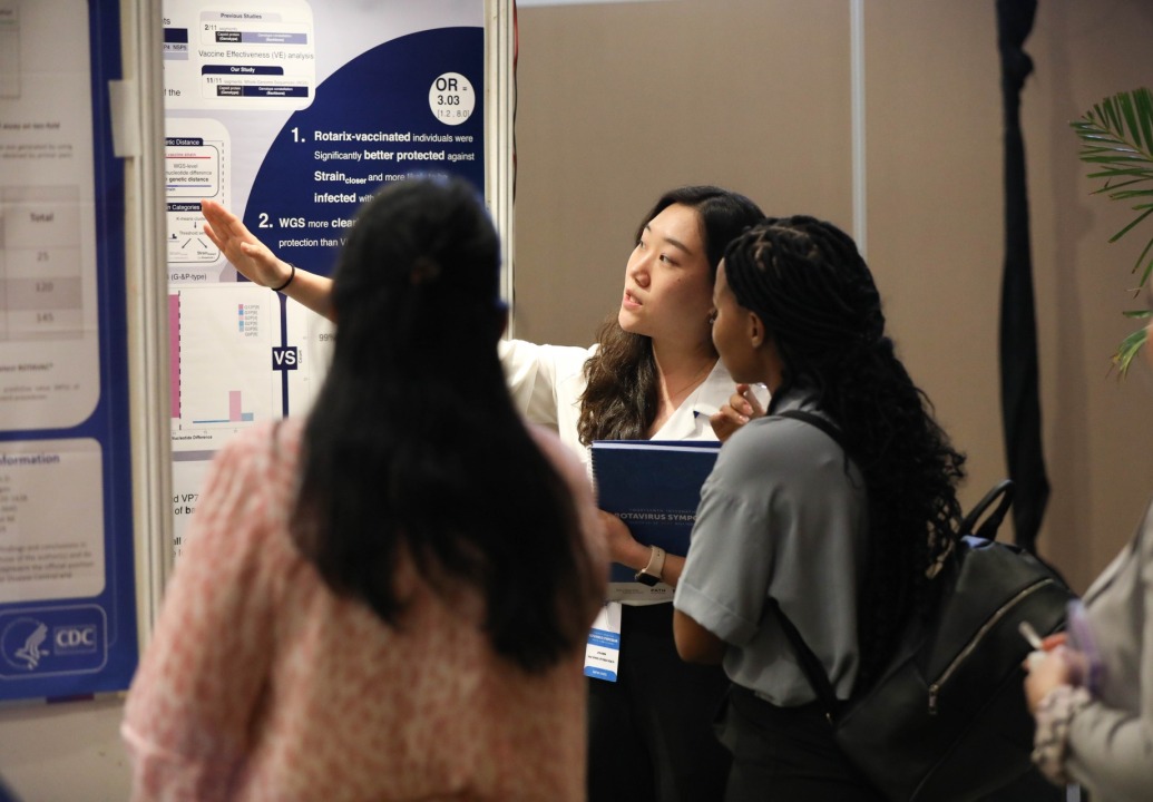 Woman pointing to a poster presentation.