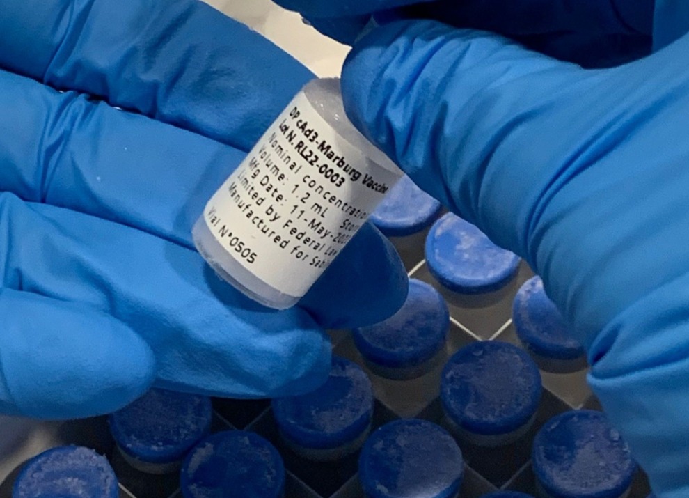 A person holding a vaccine vial.