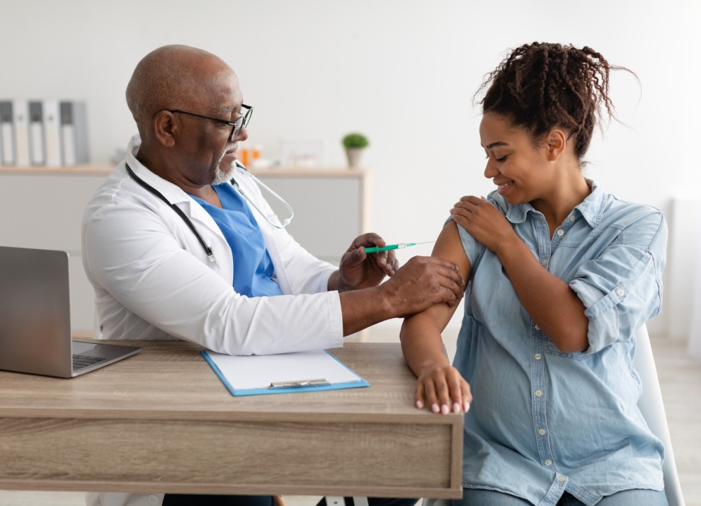Pregnant woman getting a vaccine.