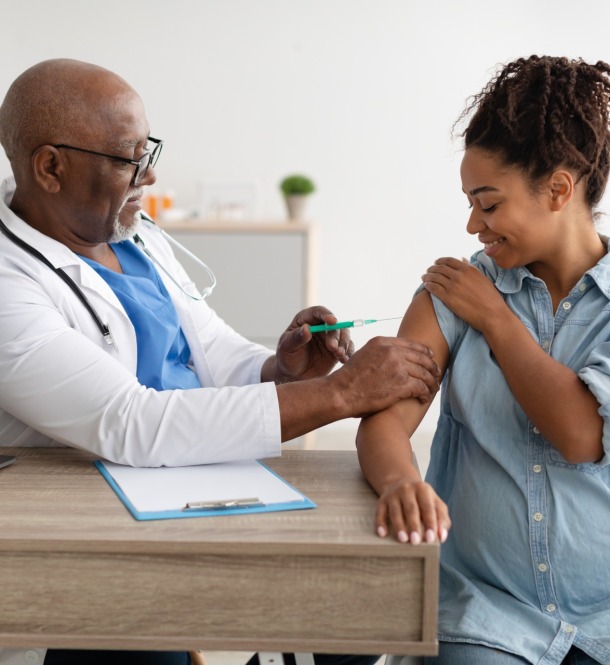 Pregnant woman getting a vaccine.